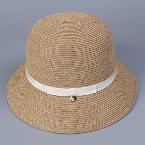 Detailed view of a Japanese style woven straw sun hat featuring a white ribbon bow