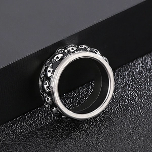 Macro shot of punk style double-row rotating skull ring with antique silver finish
