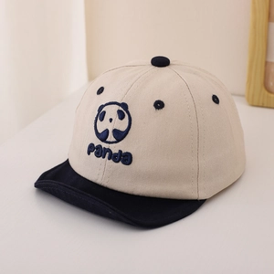 Detail of baby panda baseball cap showing navy blue embroidery on beige canvas fabric