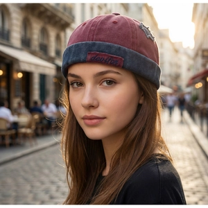 Detail of color-block docker hat with distressed holes and vintage brand label
