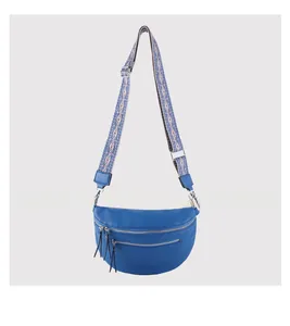 Detail of blue pebbled leather waist bag with fringe zipper and ethnic embroidered strap
