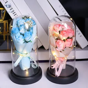 Close-up of preserved roses in glass domes with LED lights and black matte bases