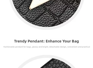 Close-up of black leather bag with embossed crocodile texture and detachable silver charm