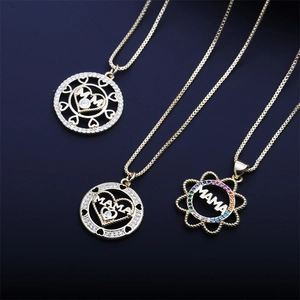 Three golden MAMA necklaces with heart and flower pendants featuring colorful crystals