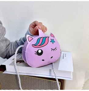 Detail of purple unicorn crossbody bag featuring cute star embroidery and top handle