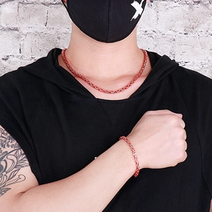 Detail of red and silver Byzantine chain necklace and bracelet set on a model