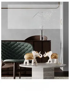Detailed relief of golden leaf veins on matte white resin elephant home decor statues
