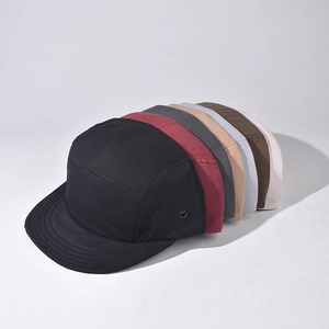 Five-panel cotton camper caps in multiple colors featuring flat brims and side metal eyelets