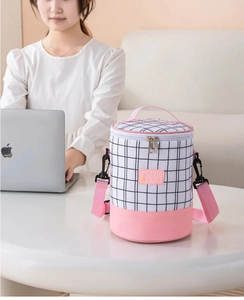 Detailed view of pink plaid insulated lunch bag with adjustable shoulder strap and handle