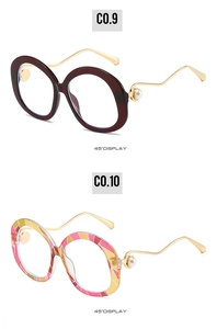 Detail view of round pearl sunglasses with gold wavy temples in burgundy and geometric patterns