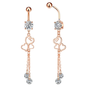 Close-up of rose gold belly ring with zircon heart pendants and dangling chains