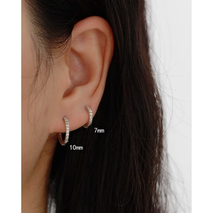 Gros plan de créoles en argent s925 de 7mm et 10mm avec sertissage en pavé de diamants