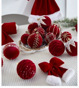 Detailed view of burgundy velvet Christmas ornaments with pearls and golden embroidery