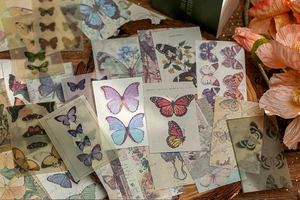 Macro shot of vintage butterfly scrapbooking stickers on a wooden texture background