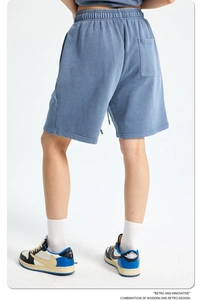 Detail of high-weight retro blue cotton shorts with elastic drawstring and rear pocket