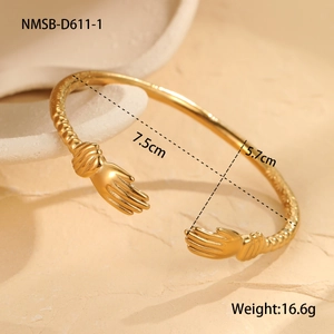 Detail view of golden hollow open cuff with hands-holding design and product dimensions