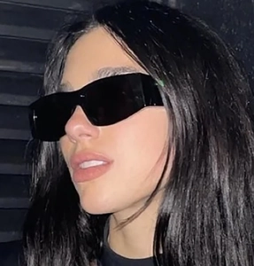 Close-up of square oversized sunglasses with wide temples on model with shadow effect