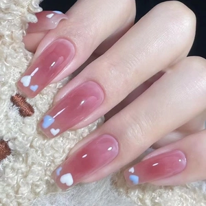 Glossy blush pink ballerina press-on nails with blue and white heart patterns