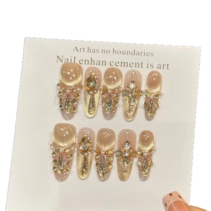 Champagne cat eye press-on nails with luxury rhinestones and crystal teardrop gems