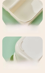 Close-up of the smooth rounded edges and anti-slip feet of this cream white bento lunch box