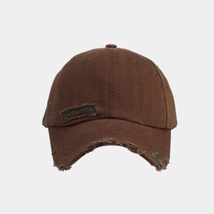 Close-up of distressed vintage baseball cap with washed fabric and embroidery details
