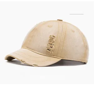 Detailed macro view of khaki distressed baseball cap with ripped brim and canvas texture