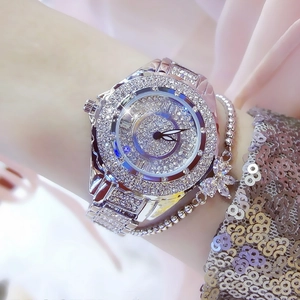 Close-up of luxury silver women's watch and butterfly bracelet set with full crystal pavé