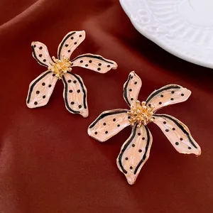 Retro cream five-petal flower earrings with black polka dots and gold core details