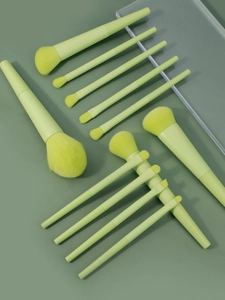 Macro view of 10 fluorescent green makeup brushes set with soft synthetic bristles