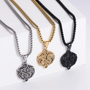 Detailed close-up of double dragon pendants in gold, silver, and black 304 stainless steel