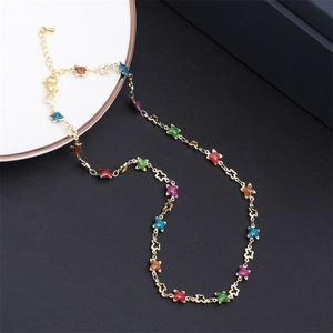 Golden necklace featuring multi-colored star charms and delicate glitter accents