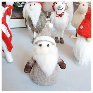 Macro shot of handmade wool felt Santa Claus ornament with detailed fiber texture