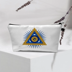 Detail of white canvas toiletry bag with golden All-Seeing Eye print and zipper