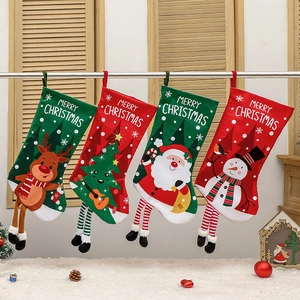 Set of four festive Christmas stockings with reindeer, Santa, and snowman designs on wood background