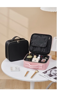 Detail showing the adjustable inner compartments and brush slots of the pink makeup bag