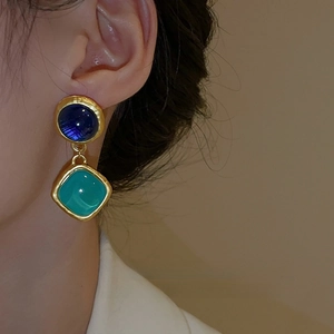 Orecchini a pendente vintage dorati con pietre blu e turchesi indossati da modella