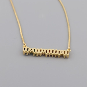 Detailed view of golden bar necklace featuring a row of vibrant rectangular rainbow zircon gems