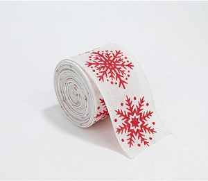 Close-up of white faux linen Christmas ribbon with printed red snowflake patterns