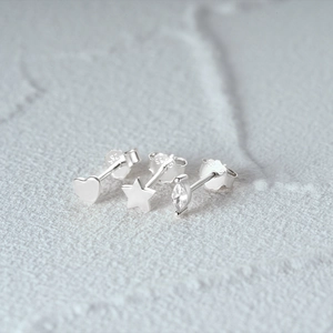 Detailed macro view of S925 sterling silver heart and star stud earrings set with zircon