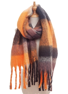 Detail of soft loop yarn plaid scarf with orange and brown check and fringe trim