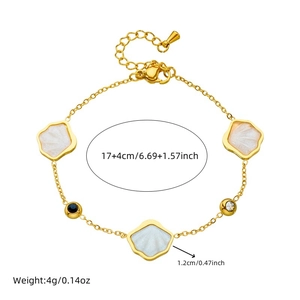 Golden stainless steel bracelet with white shell charm and black gemstone detail