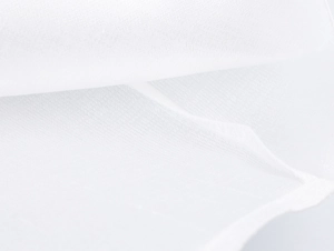 Macro shot of the white textile fabric showing the detailed fiber texture and weave pattern