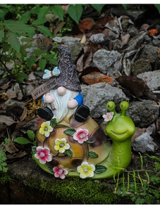 Macro detail of waterproof resin gnome gnome riding snail garden solar light decoration