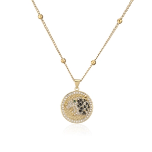 Macro shot of 18K gold plated leopard pendant with white and black cubic zirconia stones