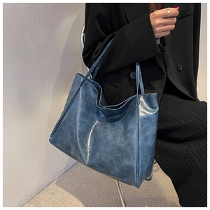 Detail view of large capacity vintage blue soft PU leather tote bag with double handles