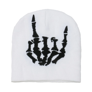 Detail of white knit beanie featuring black skeleton rock-on hand jacquard pattern