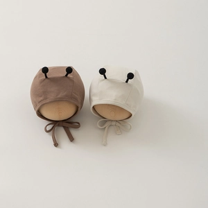 Detail of baby bee bonnets in brown and cream colors with cute elastic antennas