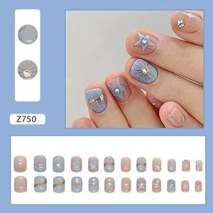 Short blue star press-on nails with gold foil and rhinestones for fashion styling