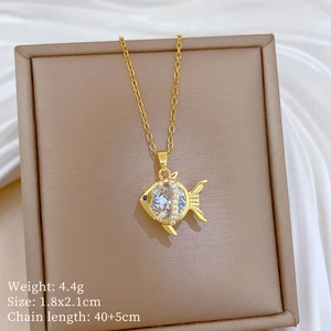 Detail view of a gold fish pendant with crystal inlay and specific product dimensions