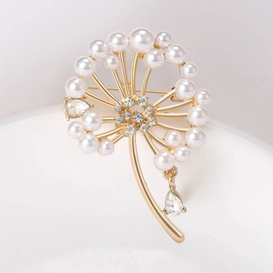 Macro de la broche pissenlit dorée avec perles élégantes et strass brillants en goutte
